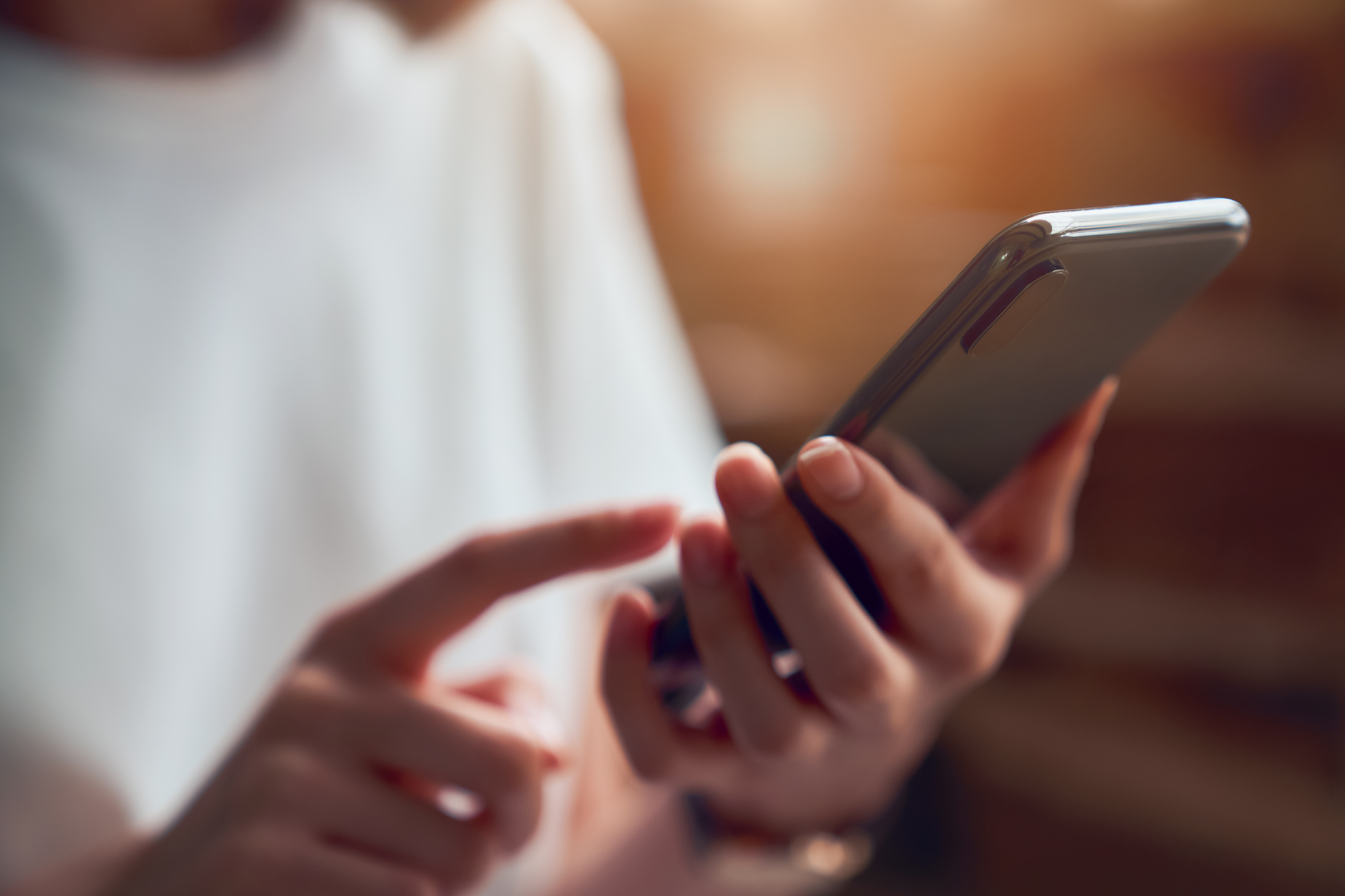 A woman scrolling on her cellphone.